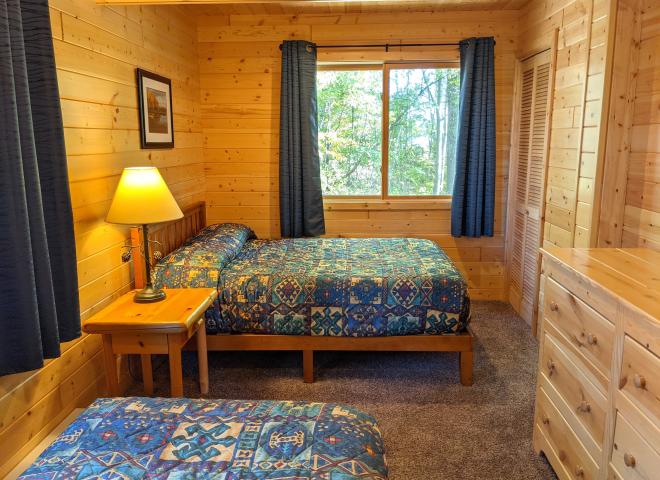 Bedroom with a full size bed and twin.