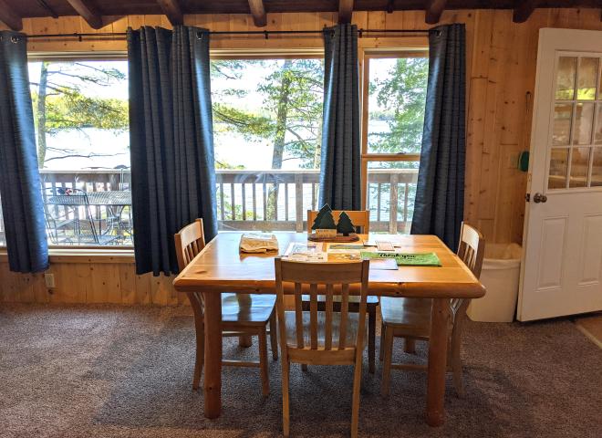 Dining area with seating and wood burning fireplace.