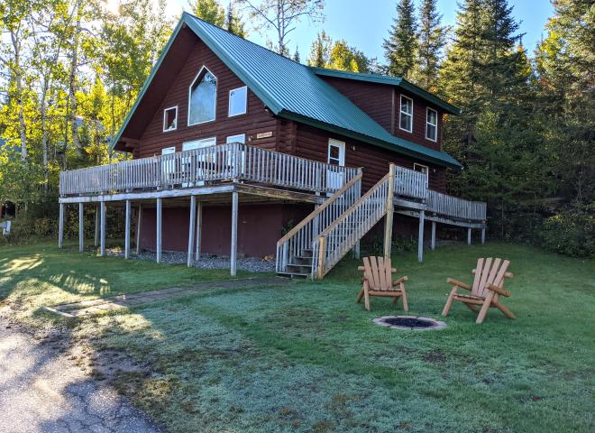 Exterior of large Sandpiper cabin with firepit.