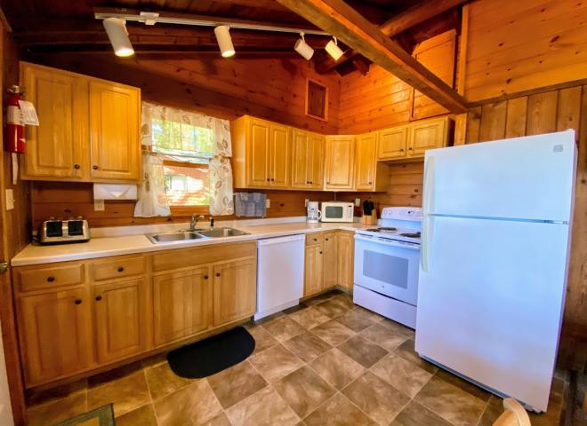 Kitchen with a refrigerator, stove, and dishwasher.