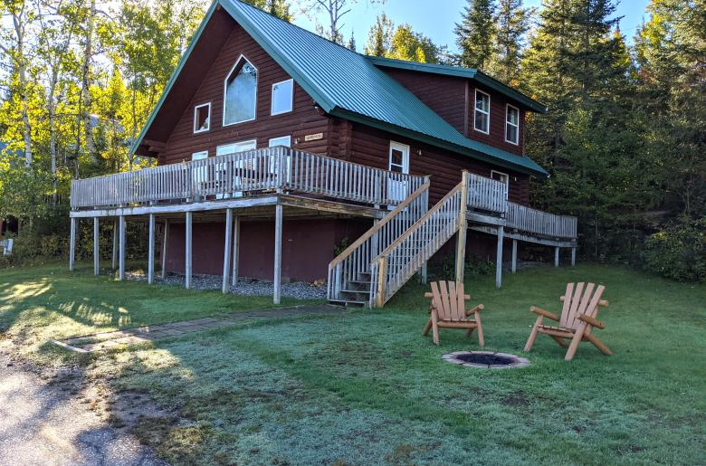 Exterior of large Sandpiper cabin with firepit.