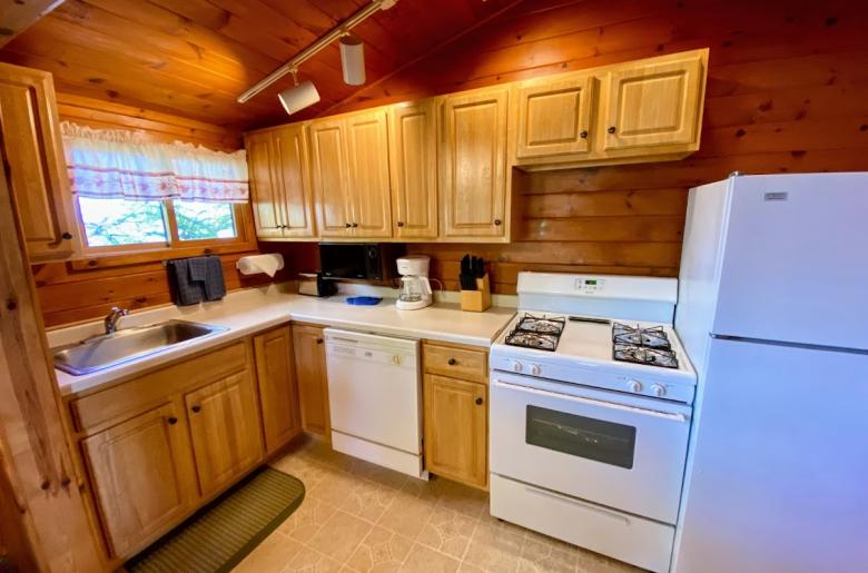 Kitchen with a standard refrigerator, stove, and dishwasher.