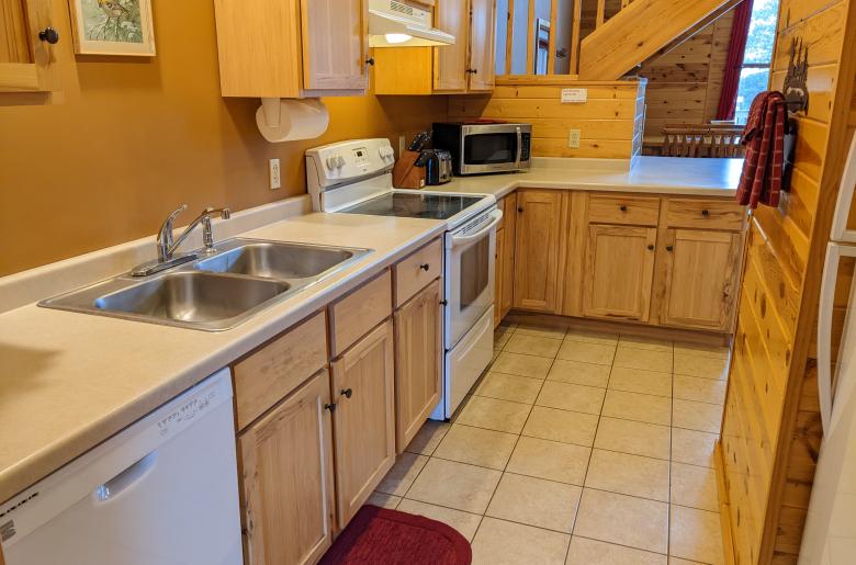 Kitchen with a refrigerator, stove, and dishwasher.