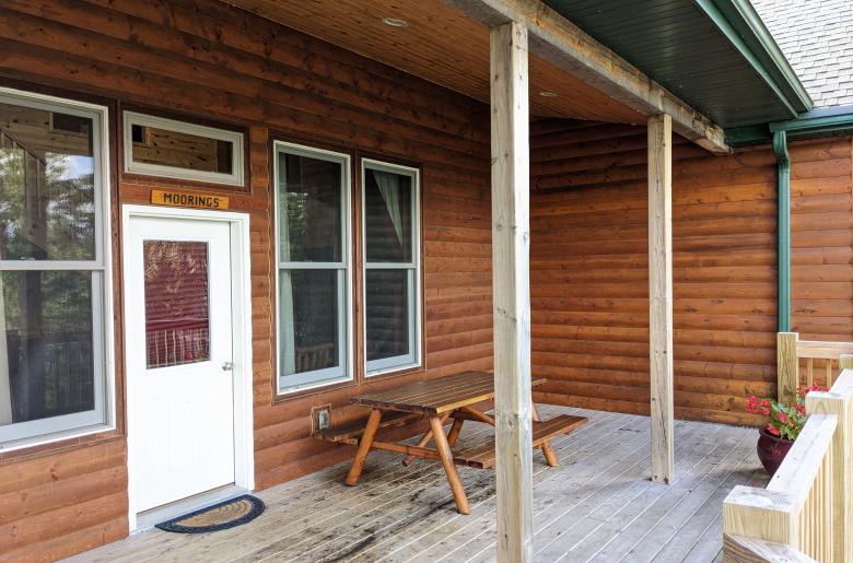 Deck entrance with picnic table.