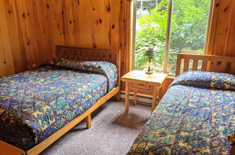 Main floor bedroom with a full size bed and twin.