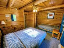 Main floor bedroom with queen and twin bed.