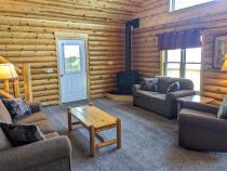 Living room with couch, loveseat, recliner, and gas fireplace.